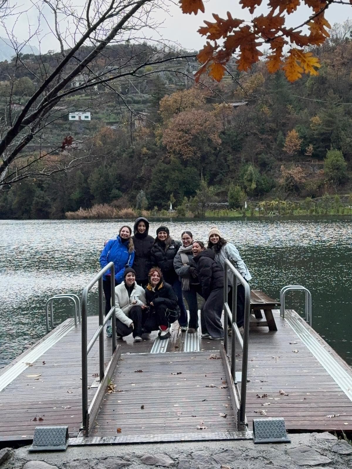Youva community gathered on a wooden pier in autumn