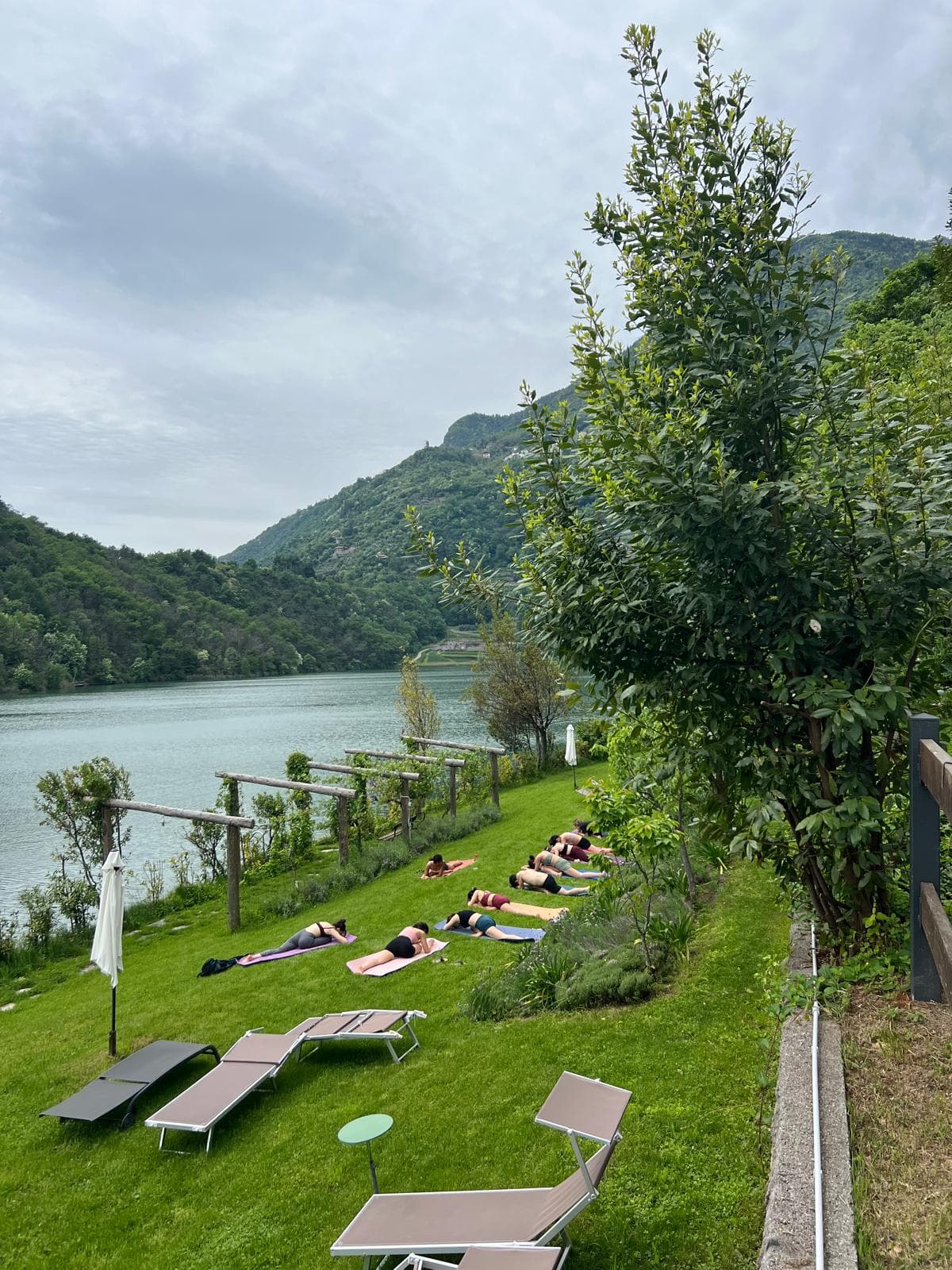 A morning yoga practice overlooking an Italian lake